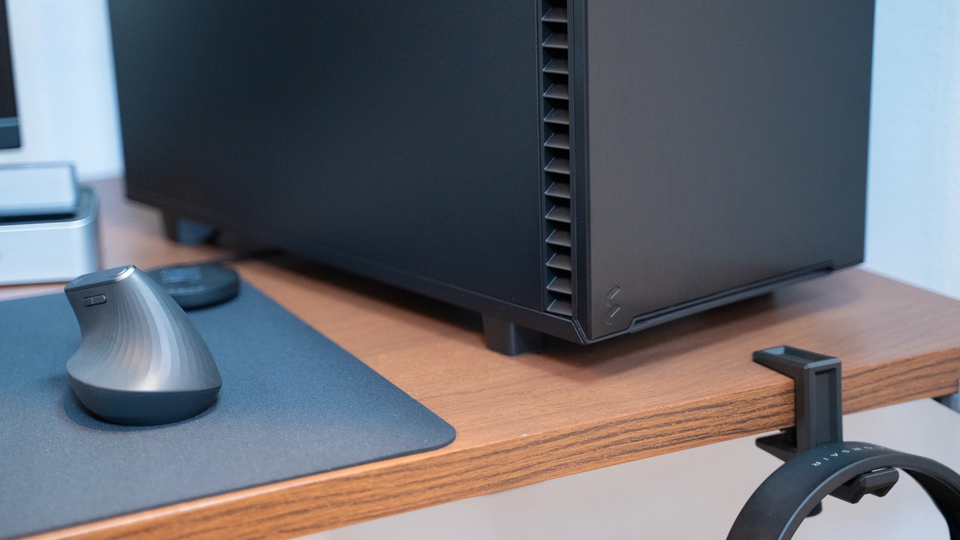 PC workstation noir compact à côté d'un moniteur